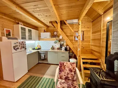 a kitchen with a white refrigerator and a staircase at Brvnaria in Slatina Varoš