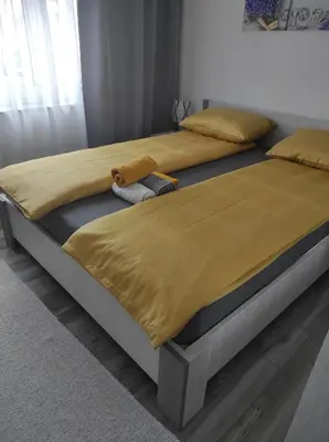 two beds sitting next to each other in a bedroom at Lavanda in Livno