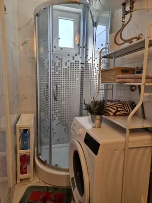 a washing machine in a bathroom with a shower at Lavanda in Livno