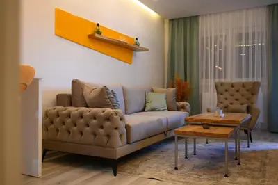 a living room with a couch and a table at Apartman Mosaic in Doboj