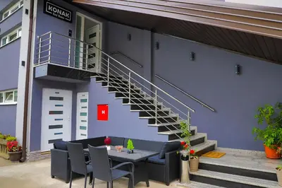 a building with a staircase and a table and chairs at Konak kod Hame in Bihać