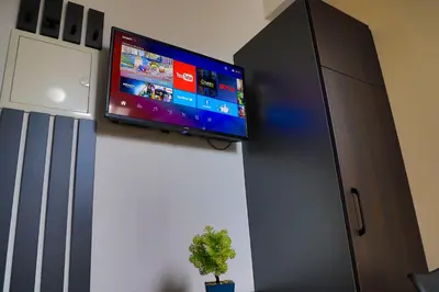 a flat screen tv on a wall in a room at Konak kod Hame in Bihać