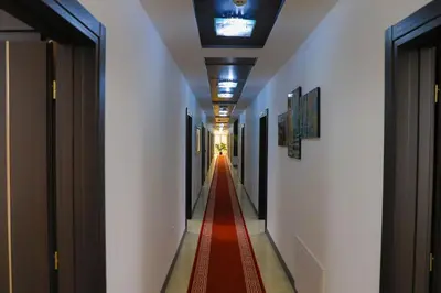 a long corridor with a red carpet in a hallway at Konak kod Hame in Bihać