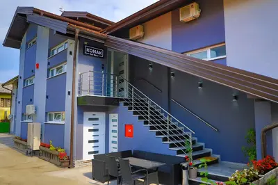 a blue building with a staircase and a table outside at Konak kod Hame in Bihać