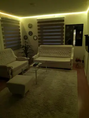 a living room with a couch and a chair at Apartment Mirror in Visoko