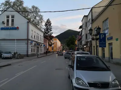 a white car parked on the side of a street at Apartment Mirror in Visoko