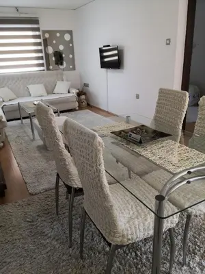 a living room with a glass table and chairs at Apartment Mirror in Visoko