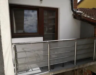 a balcony with a metal railing next to a window at Apartment Mirror in Visoko