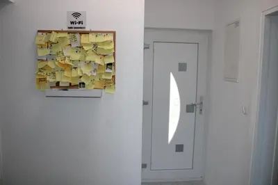 a painting hanging on a wall next to a door at AM Una Lux House in Bihać