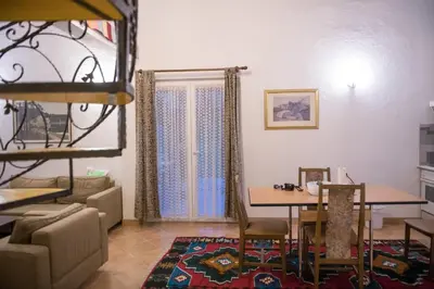 a living room with a table and a dining room at Vikendica Lohovo in Bihać