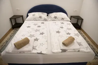 a bed with stars on it with two pillows at Vikendica Lohovo in Bihać