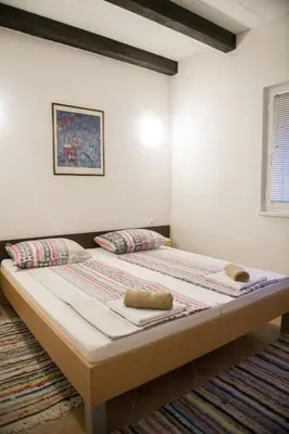 a bedroom with a large bed in a room at Vikendica Lohovo in Bihać