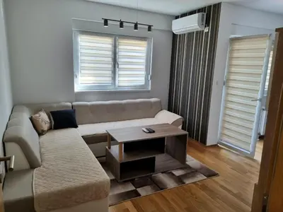 a living room with a couch and a table at Apartman Court Prijedor in Prijedor