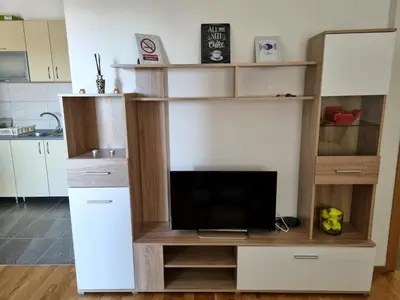 a living room with a tv in a book shelf at Apartman Court Prijedor in Prijedor