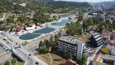 an aerial view of a city with a river at ELITE Park Lake in Tuzla