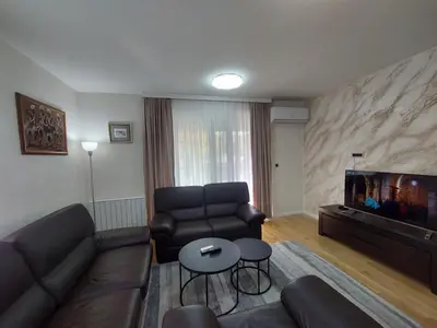 a living room with a couch and a fish tank at ELITE Park Lake in Tuzla