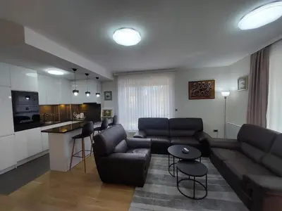 a living room with a couch and a table at ELITE Park Lake in Tuzla