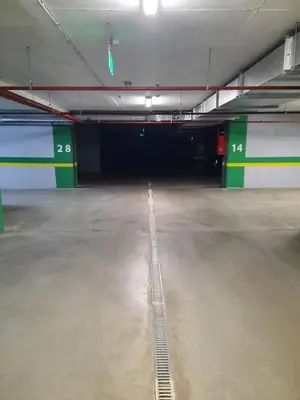 an empty parking garage with a drain in the floor at Apartman Stepe Stepanovica in Banja Luka