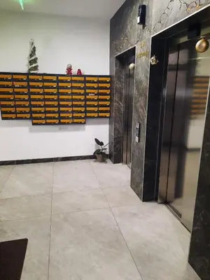 a hallway with two elevators in a building at Apartman Stepe Stepanovica in Banja Luka