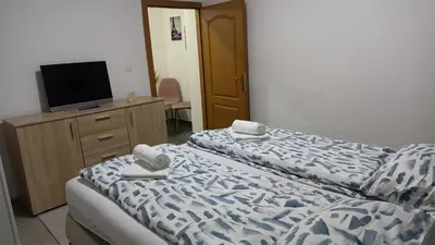 a hotel room with two beds and a television at Elita Prenoćište in Bihać