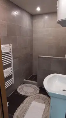 a bathroom with a sink and a tub and a toilet at Elita Prenoćište in Bihać