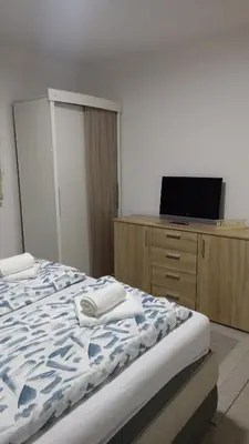 a bedroom with a bed and a tv on a dresser at Elita Prenoćište in Bihać