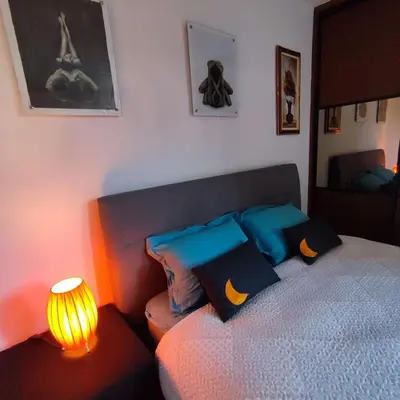 a bedroom with a bed with a lamp next to it at Apartment Wolf in Novi Travnik