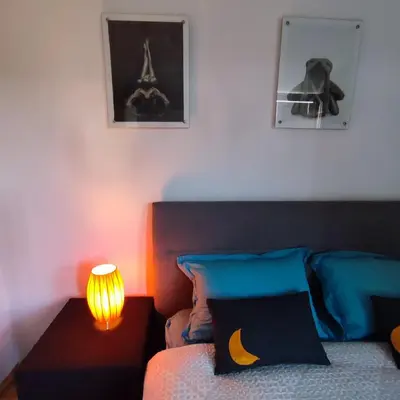 a bedroom with a bed with a lamp and the eiffel tower at Apartment Wolf in Novi Travnik