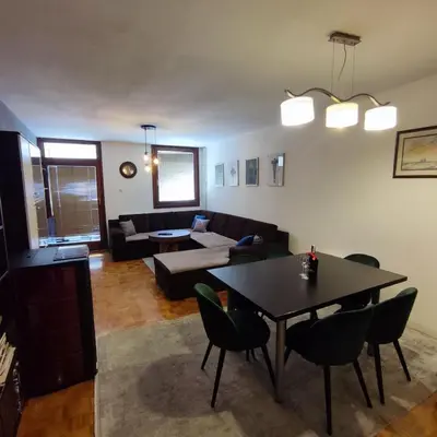 a living room with a table and a couch at Apartment Wolf in Novi Travnik