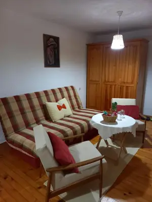 a living room with a couch and a table at Apartman Dujaković in Banja Vrućica