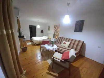 a living room with a couch and a bed at Apartman Dujaković in Banja Vrućica