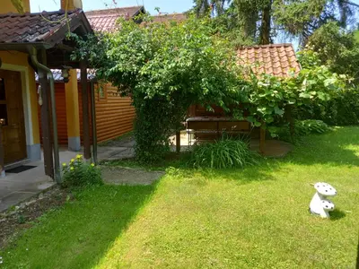 a teddy bear sitting in the grass in a yard at Apartman Dujaković in Banja Vrućica