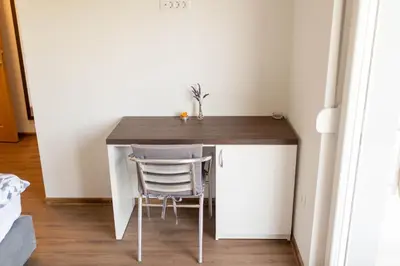 a small table in a room with two chairs at Apartmani Mia in Prozor