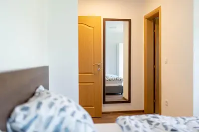 a bedroom with a mirror and a bed in a room at Apartmani Mia in Prozor