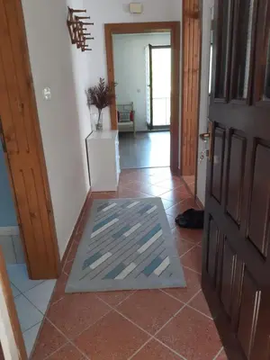 a hallway with a door and a tile floor at Apartman Emanuel in Jajce