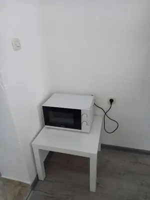 a microwave sitting on a white table in a room at Apartman Emanuel in Jajce