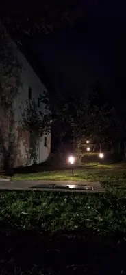 a street at night with lights in the grass at Apartman Emanuel in Jajce