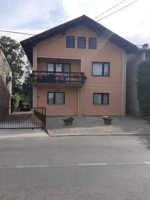 a house with a balcony with flowers on it at Apartman Dalal - with access to river Una in Bihać