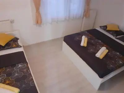 a bedroom with two beds and two pillows at Apartman Dalal - with access to river Una in Bihać