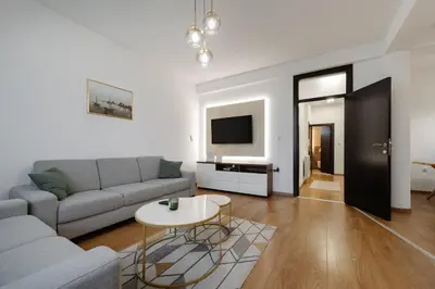 a living room with a couch and a table at Apartman Square Trg Prijedor in Prijedor