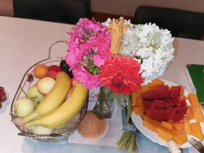 a vase of flowers and fruit on a table at Azra in Visoko