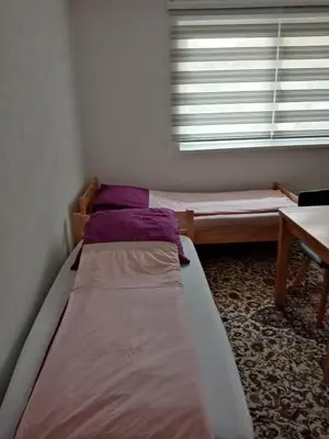a bedroom with two bunk beds and a window at Azra in Visoko