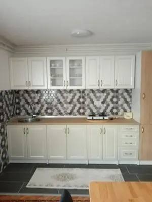 a kitchen with white cabinets and a sink at Azra in Visoko