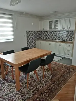 a kitchen with a wooden table and chairs at Azra in Visoko