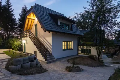 a small house with a staircase in front of it at Retro Village Ravne in Visoko