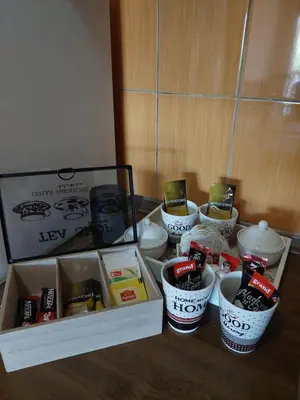 a group of bowls and other items in a cabinet at Apartment EM 2 in Tuzla
