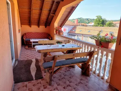 a balcony with a table and a couch at Apartment EM 2 in Tuzla
