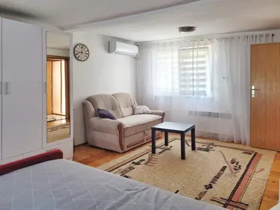 a living room with a couch and a table at Kuća Mandić in Bosanska Gradiška
