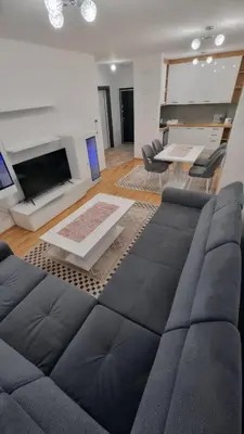 a living room with a couch and a fireplace at Valley of Pyramids Residence in Visoko