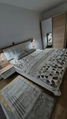 a large bed in a bedroom with a mirror at Valley of Pyramids Residence in Visoko